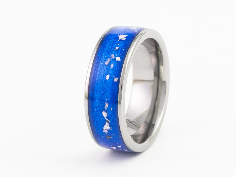 Silver tungsten ring with blue inlay featuring white speckles, side angle on white background.