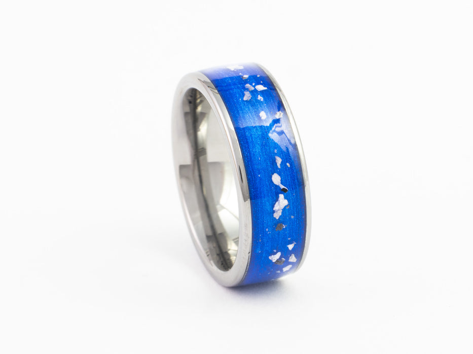 Silver tungsten ring with blue inlay and white speckles, angled view on white background.