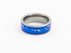 Silver tungsten ring with blue inlay and white flecks, top-down view on white background.