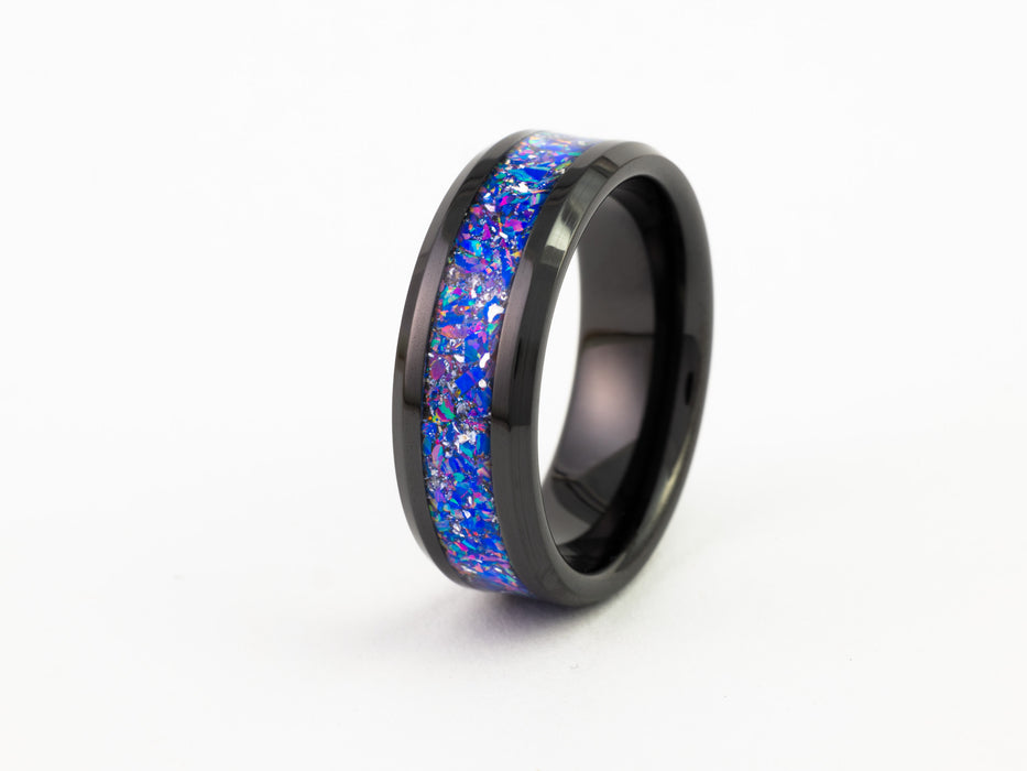 Side view of black tungsten ring with purple-blue opal inlay on a white background.