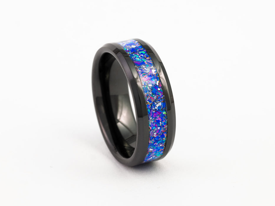 Angled view of black tungsten ring with purple-blue opal inlay