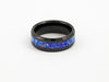 Black tungsten ring with purple-blue crushed opal inlay on white background