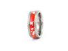 Angled view of hammered silver tungsten ring with red opal inlay