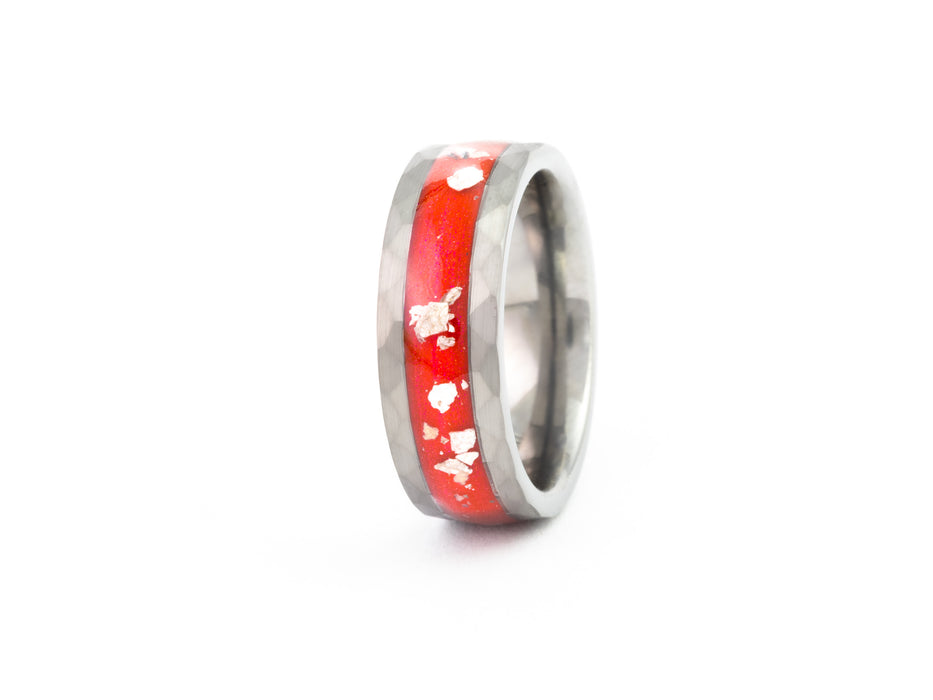 Angled view of hammered silver tungsten ring with red opal inlay