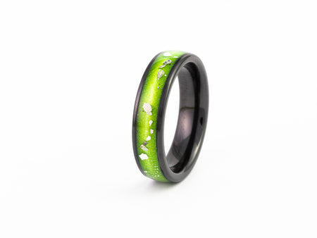 Black Ceramic Wedding Band with narrow lime green resin inlay and scattered silver leaf flakes.