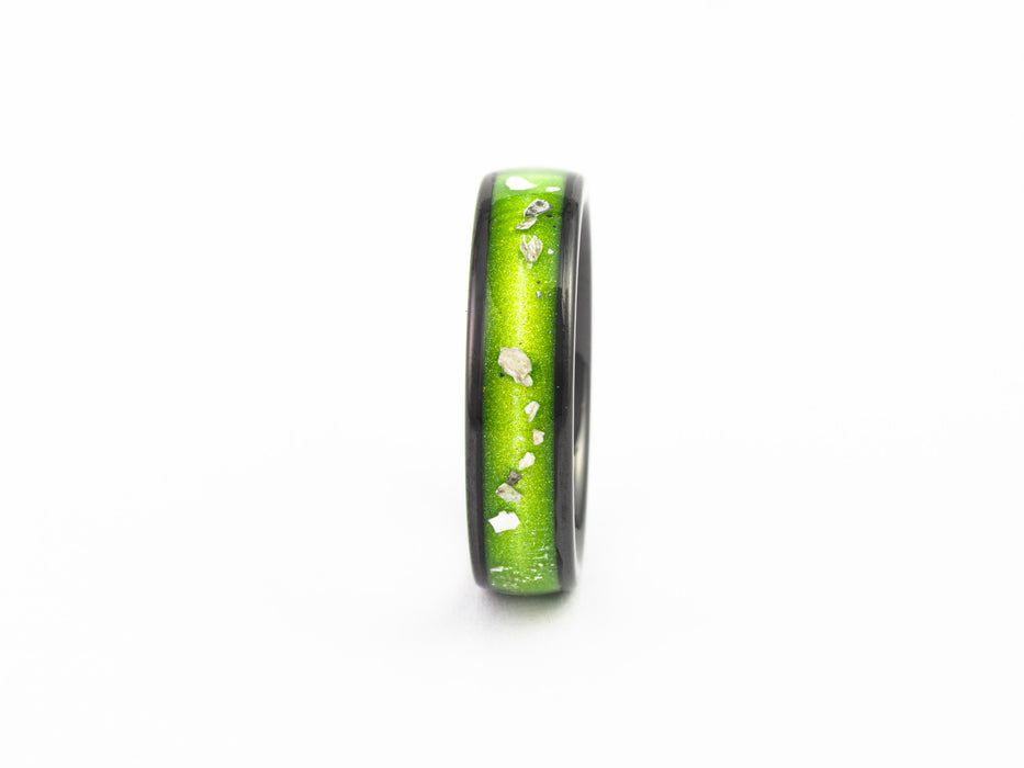Side profile close-up of the Black Ceramic Band showing the narrow lime green resin inlay with silver flakes.