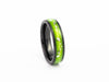 Angled view of the narrow Black Ceramic Ring with bright lime green resin and silver leaf flakes.
