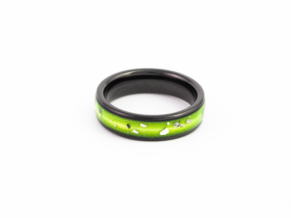 Top view of the Black Ceramic Ring showcasing the bright lime green resin inlay with silver leaf flake details.