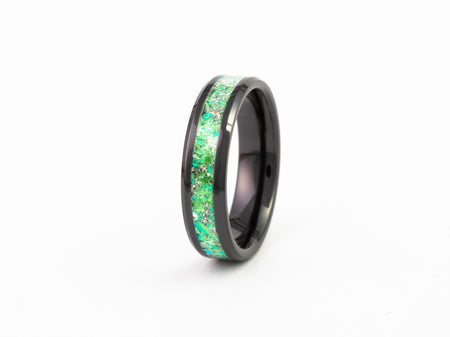 Black Ceramic Ring with bright green fire opal flake inlay band on a white background.