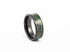 Angled studio shot of the Black Ceramic Ring with wide, dark nebula-style multicolored fire opal inlay.