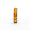 Side view of the Gunmetal Tungsten Carbide Ring detailing the orange synthetic fire opal inlay with silver flakes.
