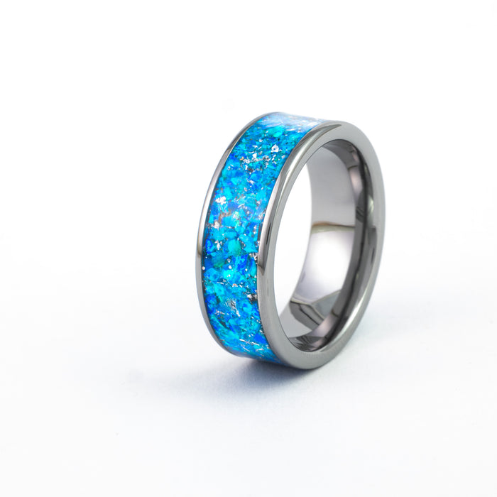 Gunmetal Tungsten Carbide Ring with wide, vibrant blue synthetic fire opal inlay and flecks of silver.