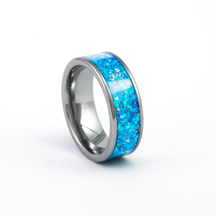 Angled studio shot of the Gunmetal Tungsten Carbide Ring with wide, vibrant blue fire opal inlay.