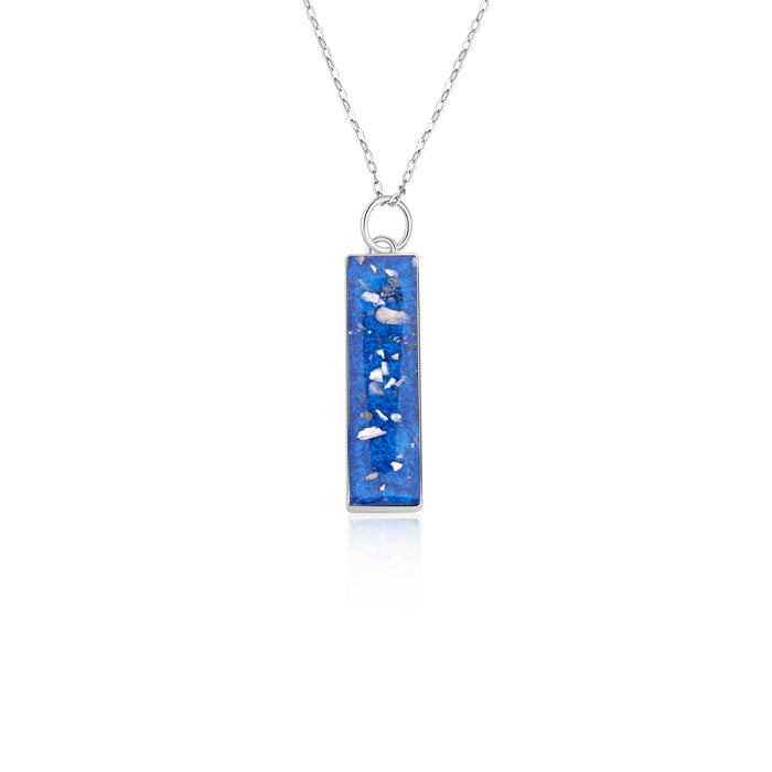 Sterling silver chain necklace with a rectangular bar pendant featuring bright blue resin and internal silver flake accents.