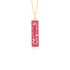 Gold-plated chain necklace with a rectangular bar pendant featuring bright pink resin and internal gold flake accents.