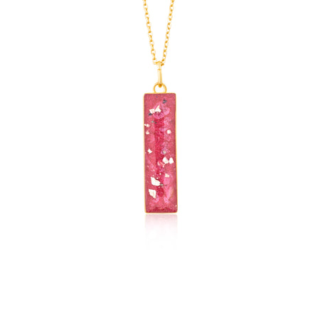 Gold-plated chain necklace with a rectangular bar pendant featuring bright pink resin and internal gold flake accents.