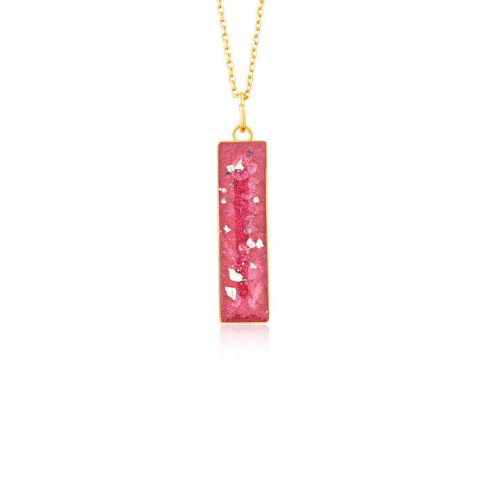 Gold-plated chain necklace with a rectangular bar pendant featuring bright pink resin and internal gold flake accents.