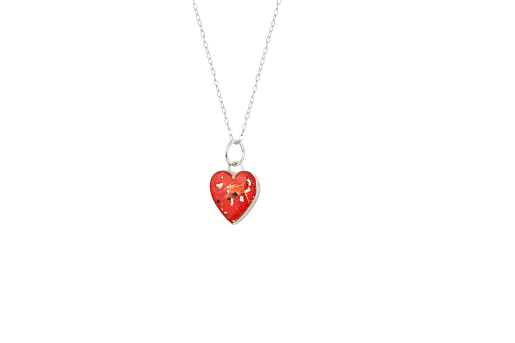 Sterling silver heart pendant necklace with red resin inlay and gold flake accents.