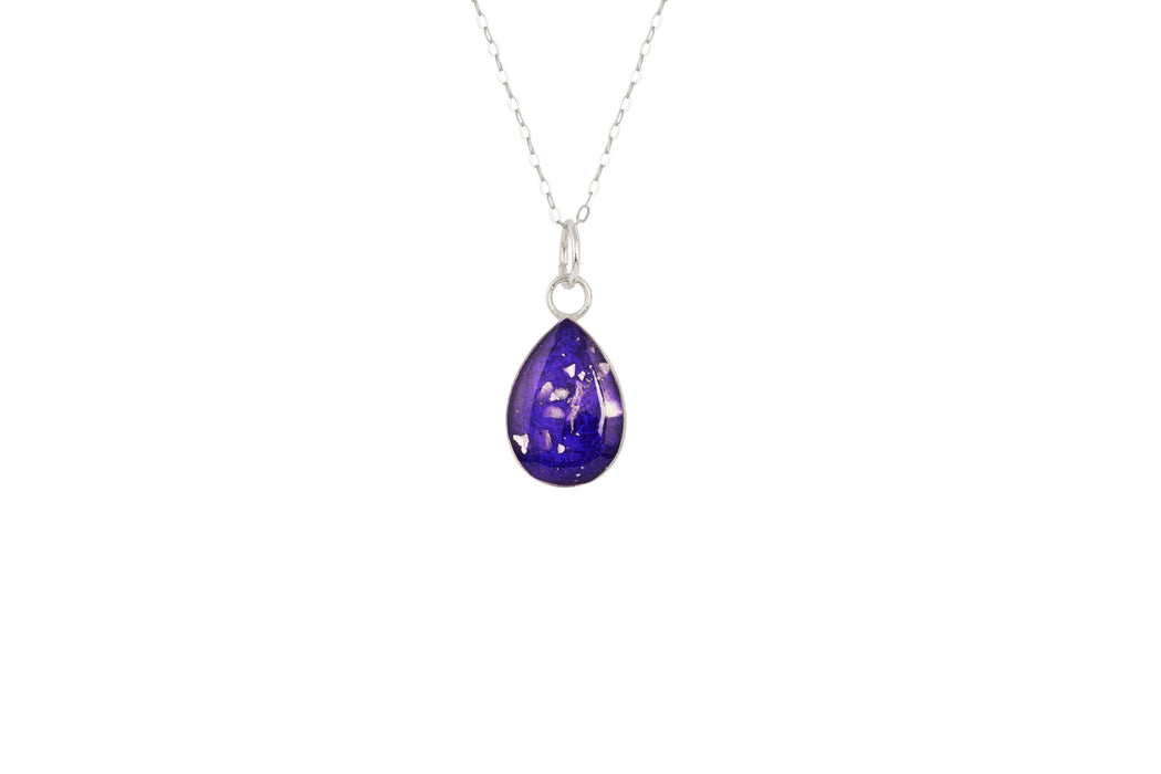 Sterling silver chain with a pear-cut teardrop pendant featuring a deep purple resin inlay and internal silver flake accents.