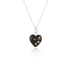 Sterling silver chain necklace with a heart-shaped pendant featuring black resin inlay and internal silver flake accents.