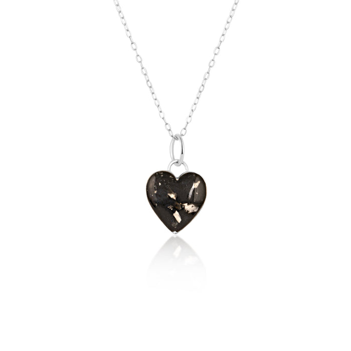 Sterling silver chain necklace with a heart-shaped pendant featuring black resin inlay and internal silver flake accents.
