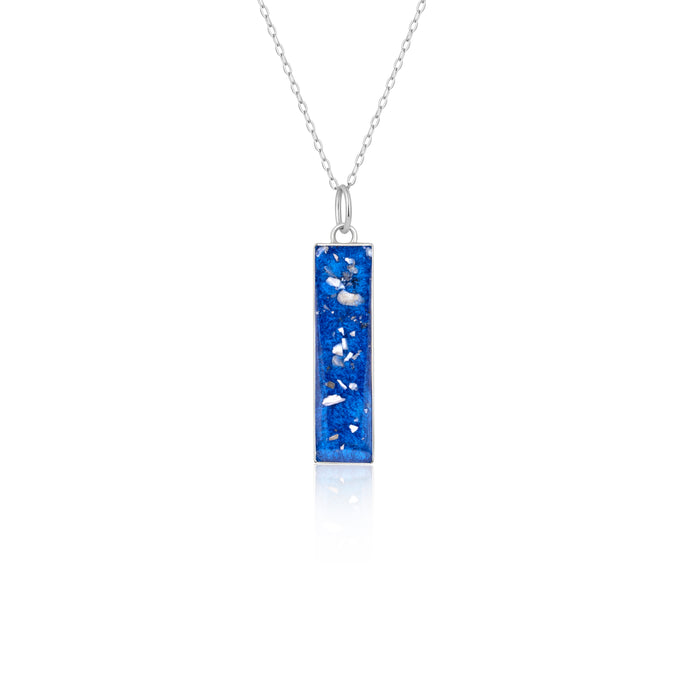 Sterling silver chain necklace with a rectangular bar pendant featuring bright blue resin and internal silver flake accents.