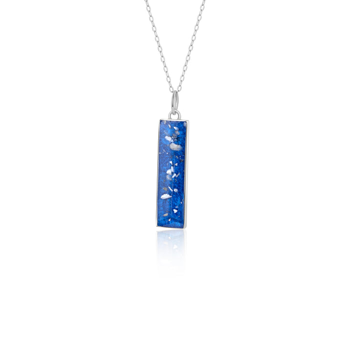 Sterling silver chain necklace with a rectangular bar pendant featuring bright blue resin and internal silver flake accents.