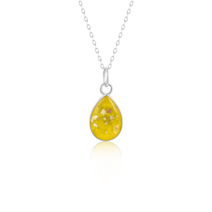 Sterling silver chain necklace with a pear-cut teardrop pendant featuring a yellow resin inlay with white flake accents.