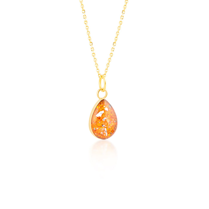 Gold-plated chain necklace with a pear-cut teardrop pendant featuring vibrant orange resin and internal gold and silver flake accents.