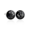 Pair of sterling silver cufflinks featuring round black resin inlays with scattered white and silver flake accents.