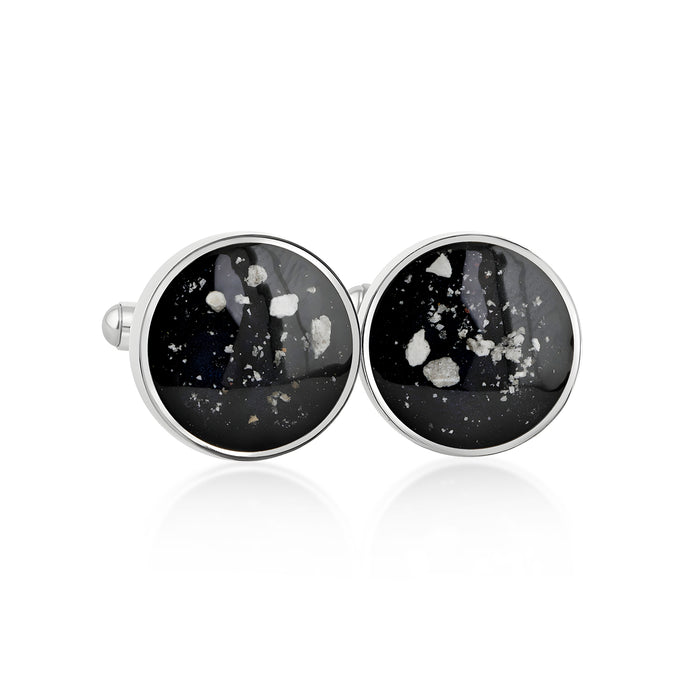 Pair of sterling silver cufflinks featuring round black resin inlays with scattered white and silver flake accents.