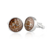 Pair of sterling silver cufflinks featuring round bronze-brown resin inlays with gold and silver flake accents.