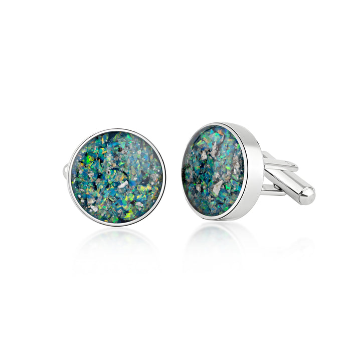 Pair of sterling silver cufflinks featuring round blue and green opal resin inlays with internal silver flakes.