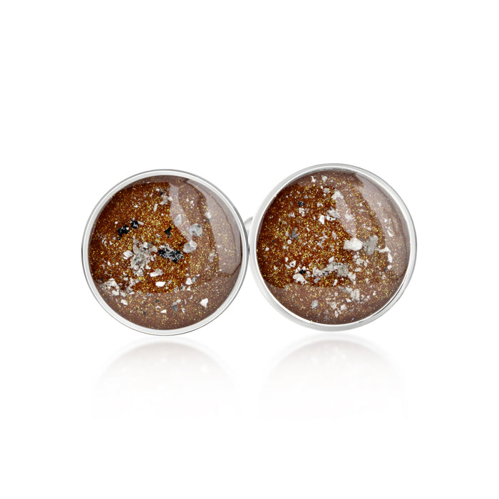 Pair of sterling silver stud earrings featuring round bronze-brown resin inlays with gold and silver flake accents.