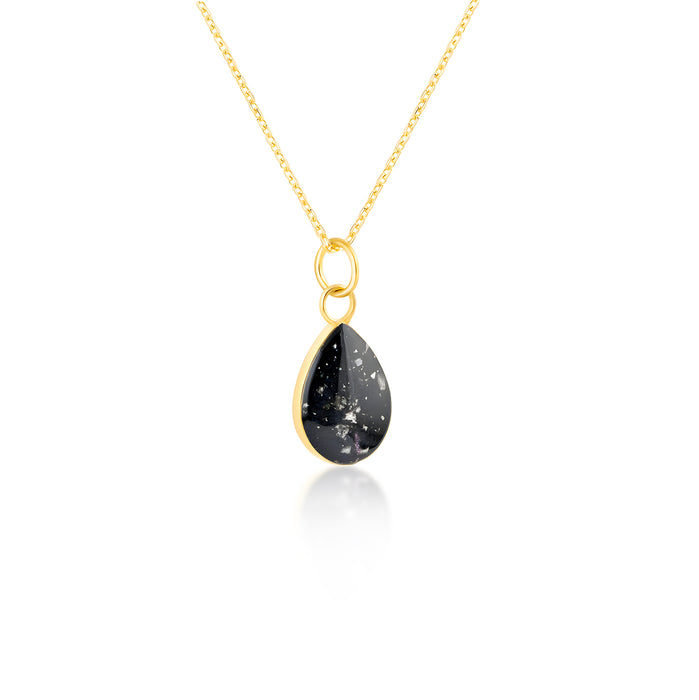 Gold-plated chain necklace with a pear-cut teardrop pendant featuring black resin and subtle white flake accents.