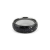 Wide sterling silver band ring featuring a continuous inlay of black resin with scattered white and silver flakes.