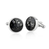 Pair of sterling silver cufflinks featuring round black resin inlays with scattered white and silver flake accents.