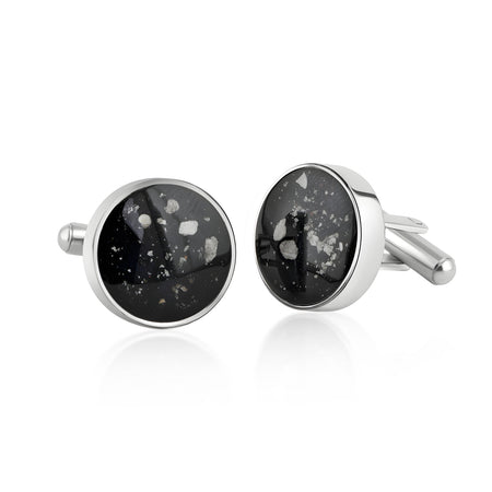 Pair of sterling silver cufflinks featuring round black resin inlays with scattered white and silver flake accents.