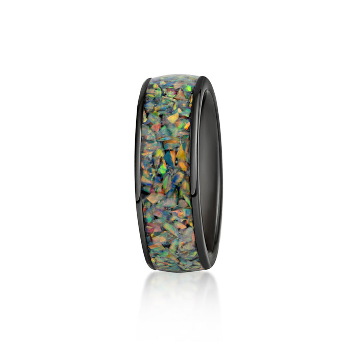 Ring with a wide, black inner band and a continuous inlay of multicolored black opal resin.