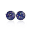 Pair of sterling silver cufflinks featuring round blue and purple resin inlays with scattered silver flakes.