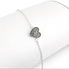 Silver chain bracelet displayed on a white stand, featuring a heart-shaped charm inlaid with multicolored opal resin.