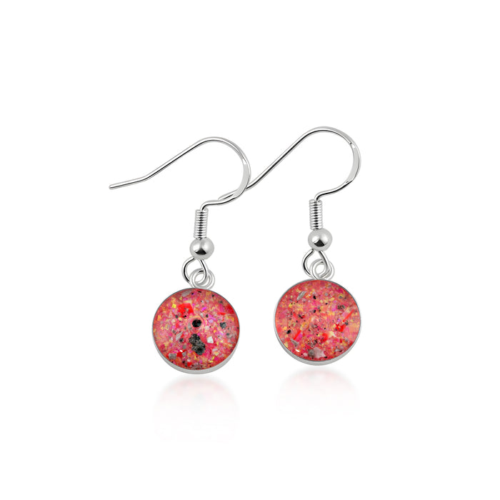 Pair of sterling silver drop earrings with fishhook wires, round red and pink opal resin inlays with scattered black and silver flakes.