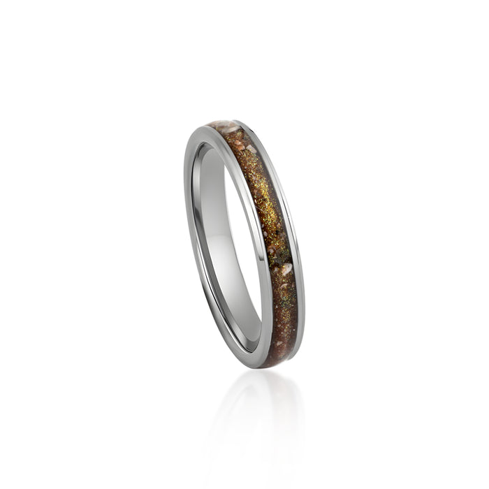 Thin sterling silver band ring featuring a continuous inlay of brown resin with gold and silver flake accents.