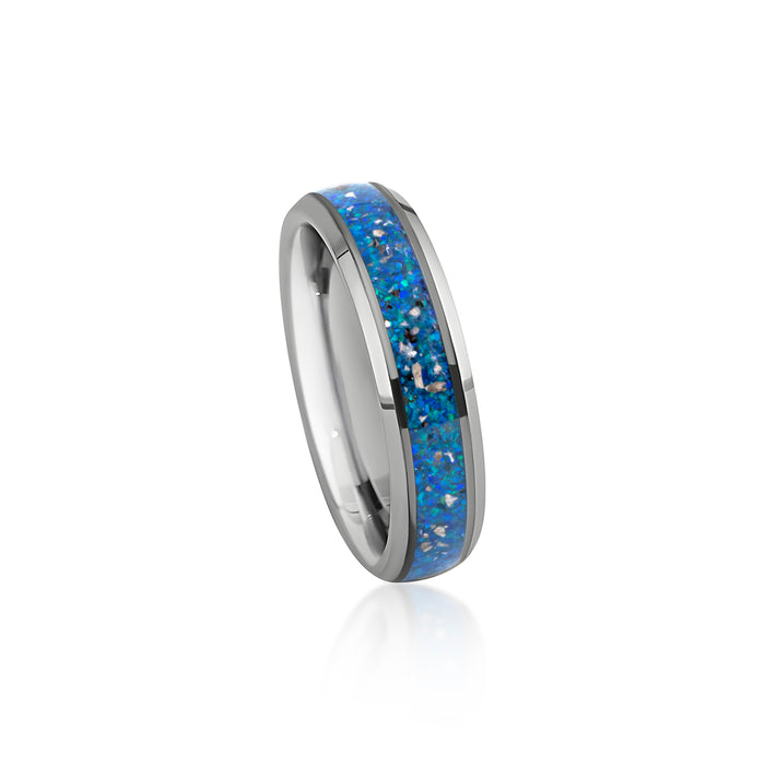 Sterling silver band ring featuring a continuous inlay of bright blue opal resin and scattered silver flakes.