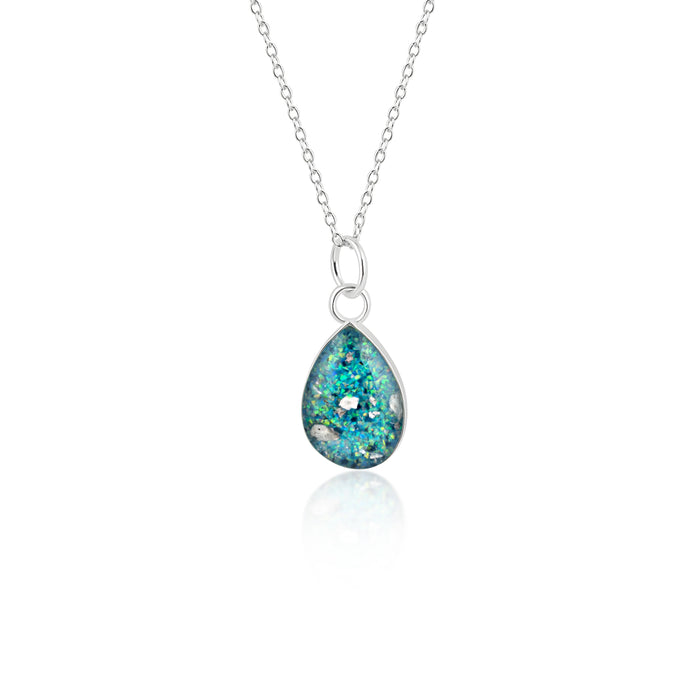 Sterling silver chain necklace with a pear-cut teardrop pendant featuring vibrant teal blue resin and internal silver flake accents.