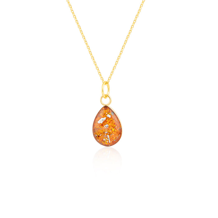 Gold-plated chain necklace with a pear-cut teardrop pendant featuring vibrant orange resin and internal gold and silver flake accents.