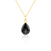 Gold-plated chain necklace with a pear-cut teardrop pendant featuring black resin and subtle white and purple flake accents.