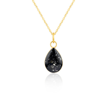 Gold-plated chain necklace with a pear-cut teardrop pendant featuring black resin and subtle white and purple flake accents.