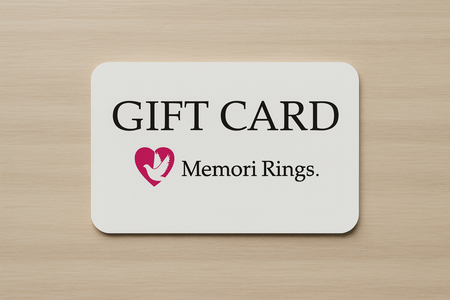 Memori Rings branded Gift card on a flat wooden surface.