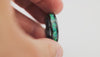Footage showing the 360-degree rotation of the Black Ceramic Ring, highlighting the bright green fire opal inlay.